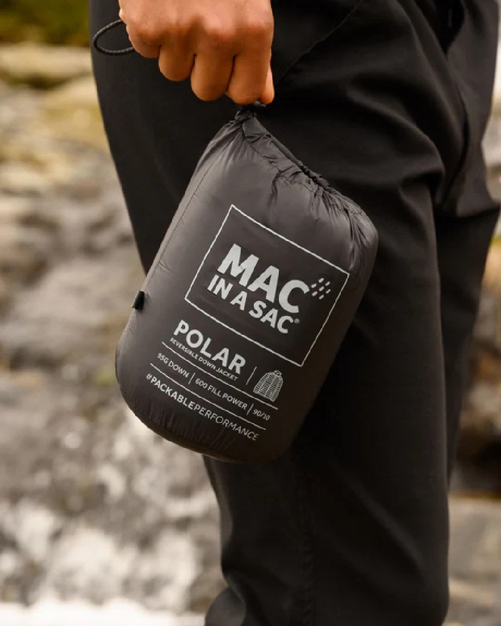 Jet Black Charcoal coloured Mac In A Sac Packable Mens Polar Down Jacket on blurry background 