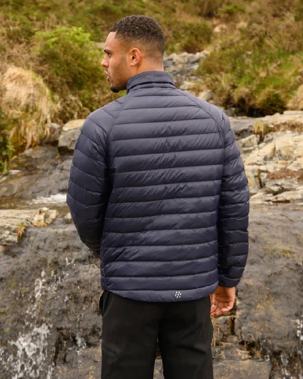 Navy Saxe Blue coloured Mac In A Sac Packable Mens Polar Down Jacket on blurry green background 