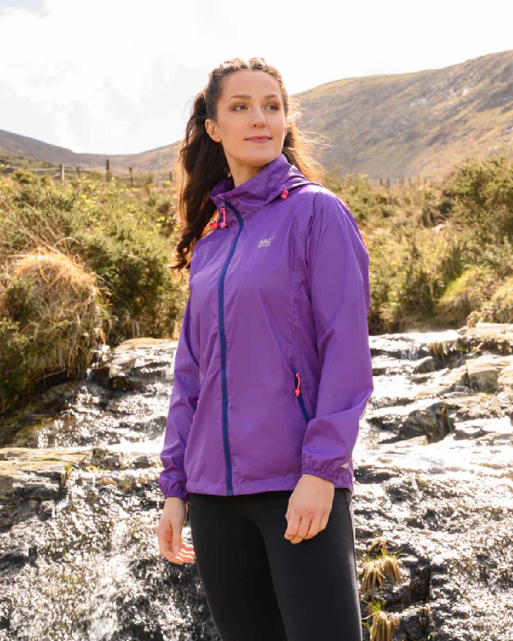 Purple coloured Mac In A Sac Packable Origin Waterproof Jacket on blurry background 