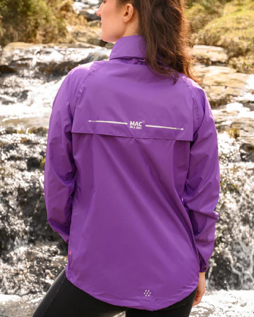Purple coloured Mac In A Sac Packable Origin Waterproof Jacket on blurry background 