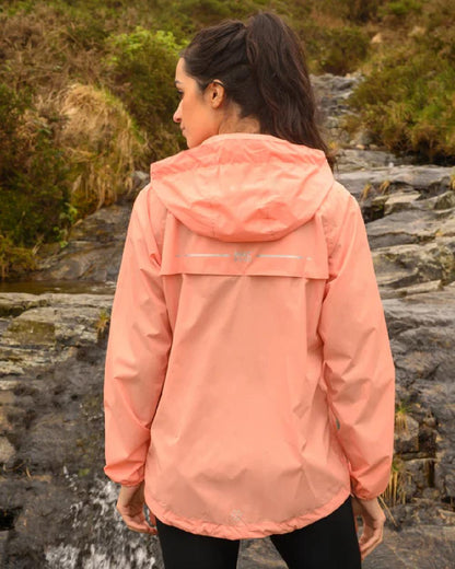 Soft Coral coloured Mac In A Sac Packable Origin Waterproof Jacket on blurry background 
