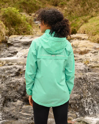 Tiffany Green coloured Mac In A Sac Packable Origin Waterproof Jacket on blurry background 