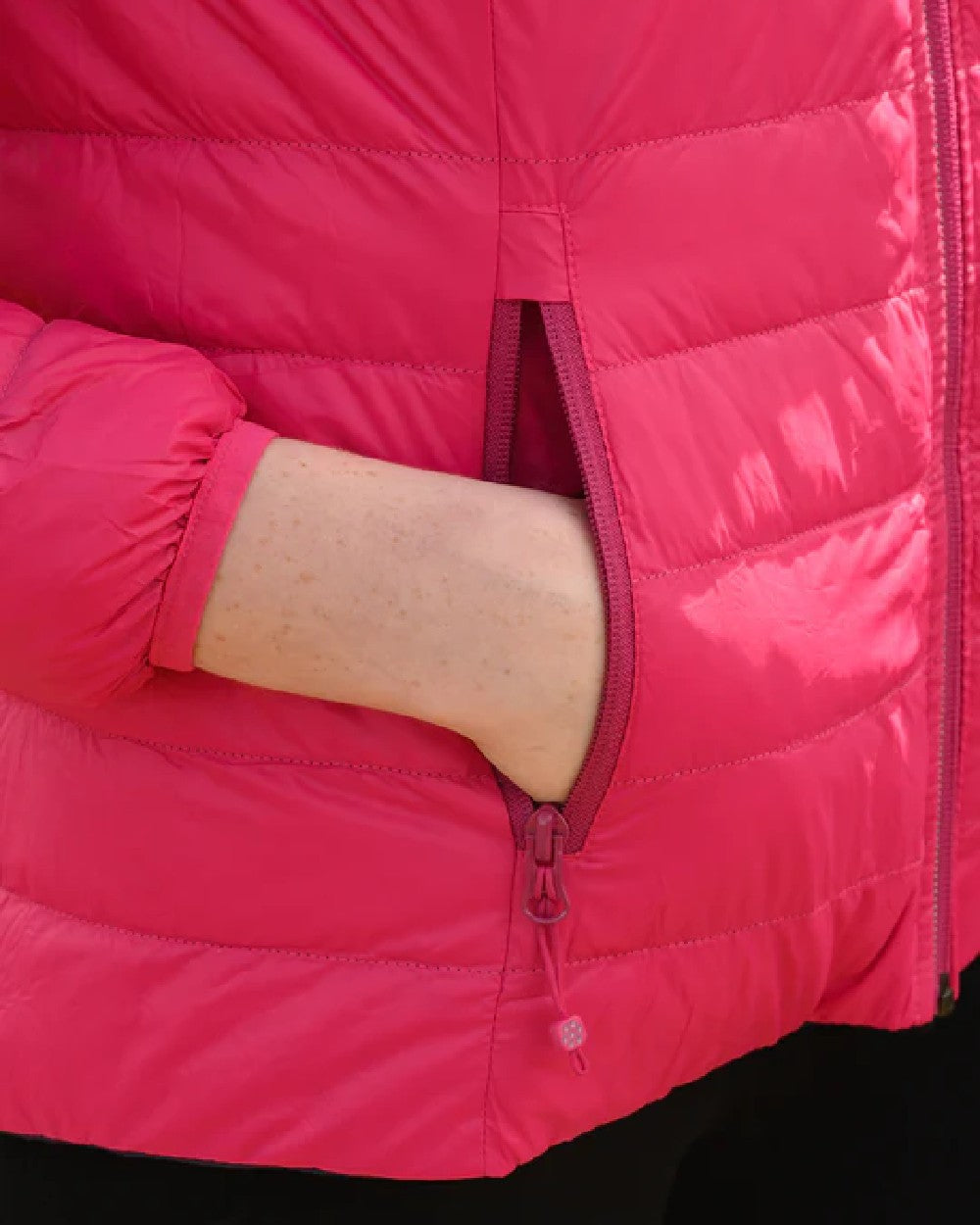 Fuchsia Navy coloured Mac In A Sac Packable Womens Down Jacket on blurry background 