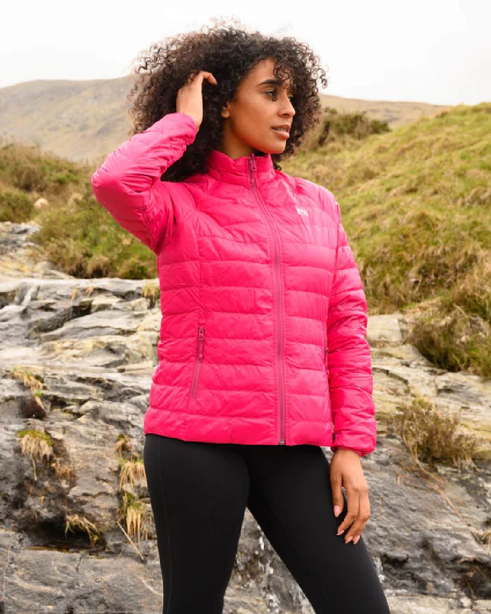 Fuchsia Navy coloured Mac In A Sac Packable Womens Down Jacket on blurry background 