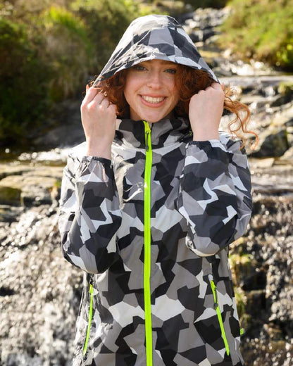 White Camo coloured Mac In A Sac Packable Origin Camo Waterproof Jacket on blurry background 