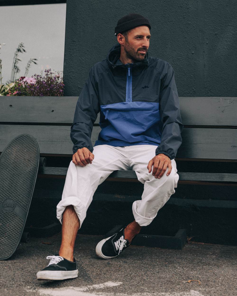 Navy Blue coloured Mac In A Sac Nomad Waterproof Half Zip Jacket on outdoor background 