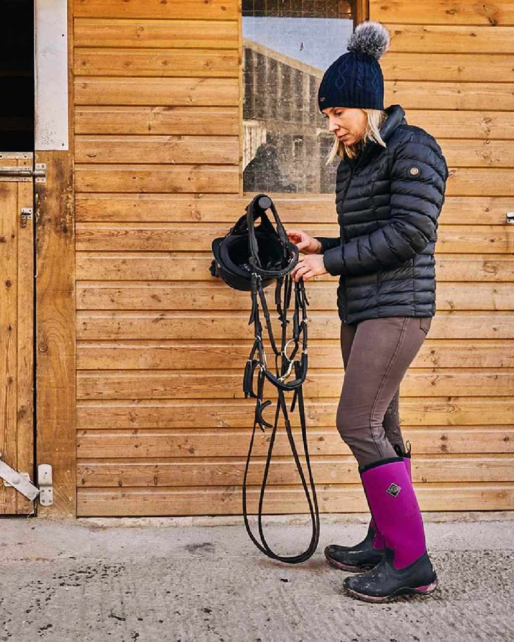 Maroon Coloured Muck Boots Womens Arctic Adventure Tall Boots on outdoor background 