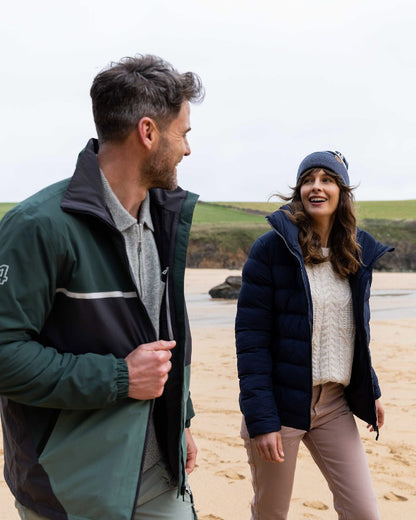 Ombre Blue Coloured Musto Bobble Hat on beach background 