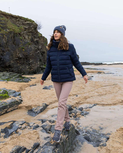 Ombre Blue Coloured Musto Bobble Hat on beach background 