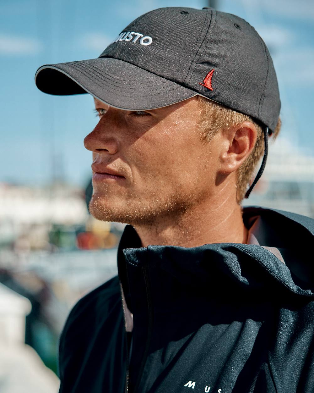 Black coloured Musto Essential Fast Dry Crew Cap on outdoor background 