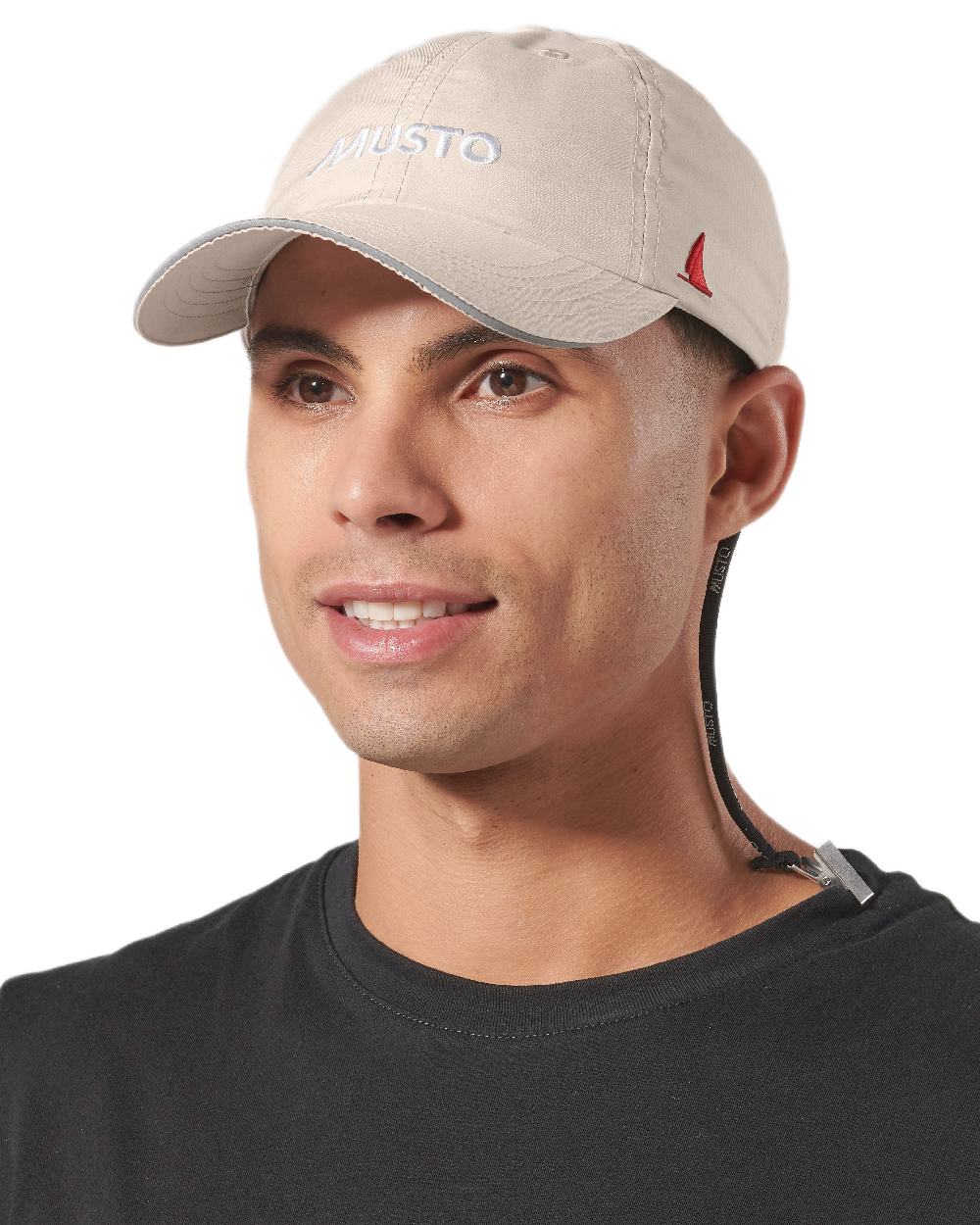 Light Stone coloured Musto Essential Fast Dry Crew Cap on white background 
