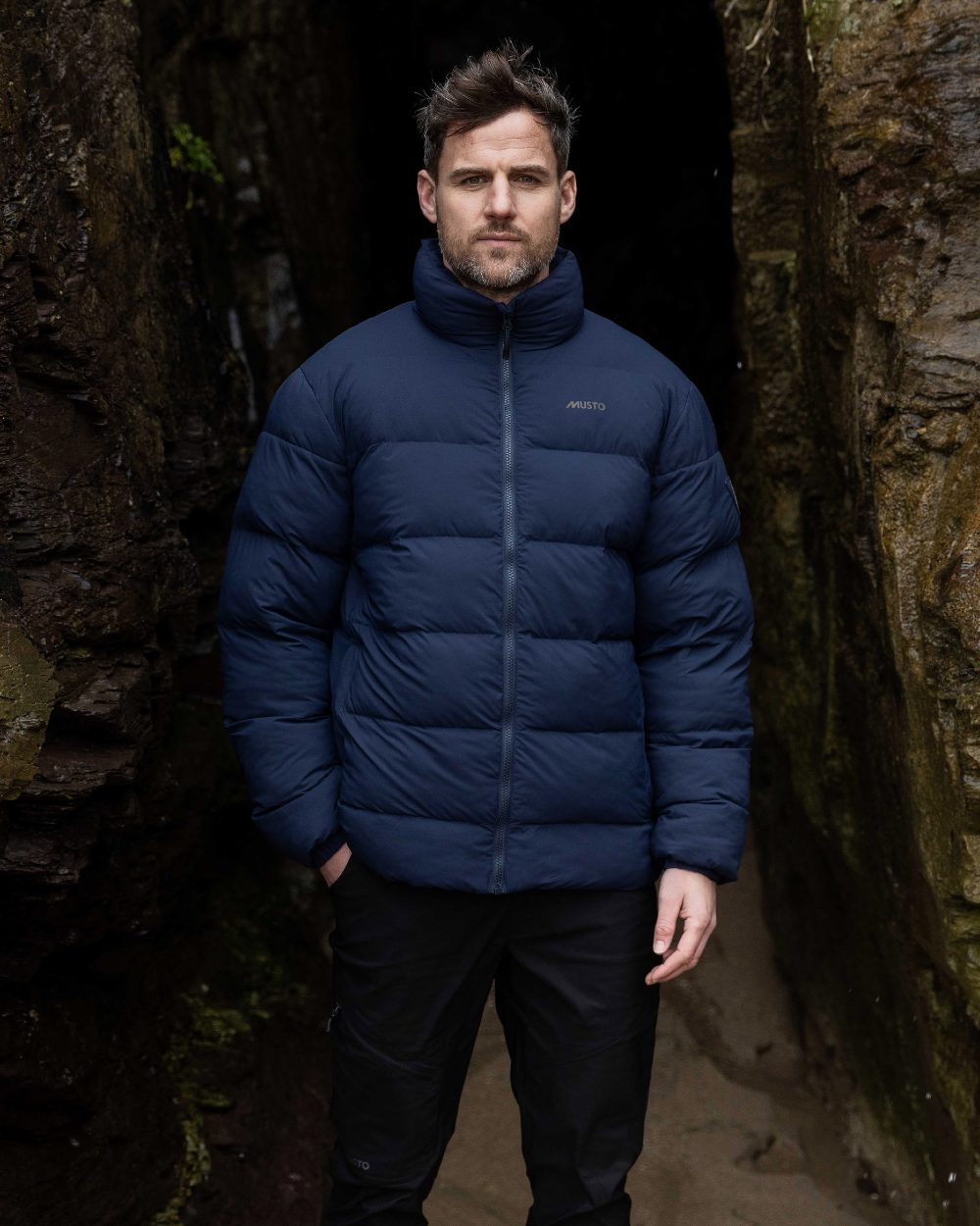 Navy Coloured Musto Mens Active Puffer Jacket on mountain background 