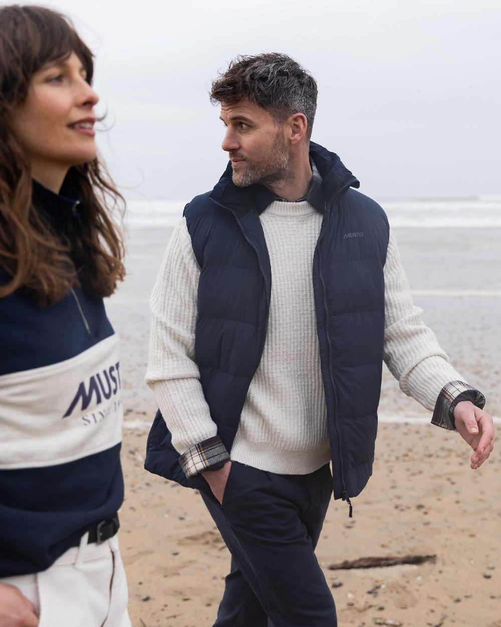 Navy Coloured Musto Mens Active Puffer Vest on beach background 