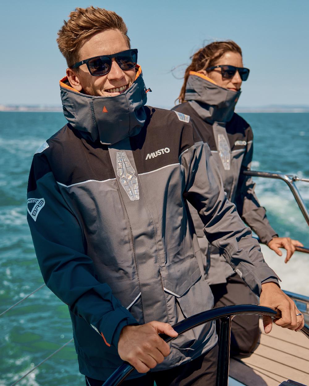Charcoal coloured Musto Mens BR3 Pertex Offshore Jacket on sea background 