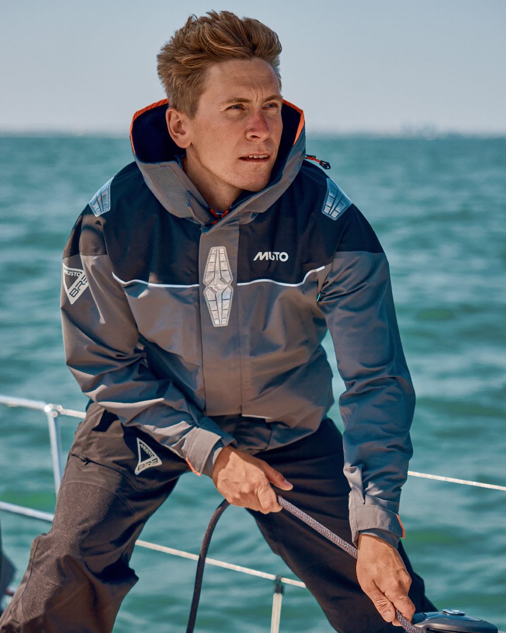 Charcoal coloured Musto Mens BR3 Pertex Offshore Jacket on sea background 