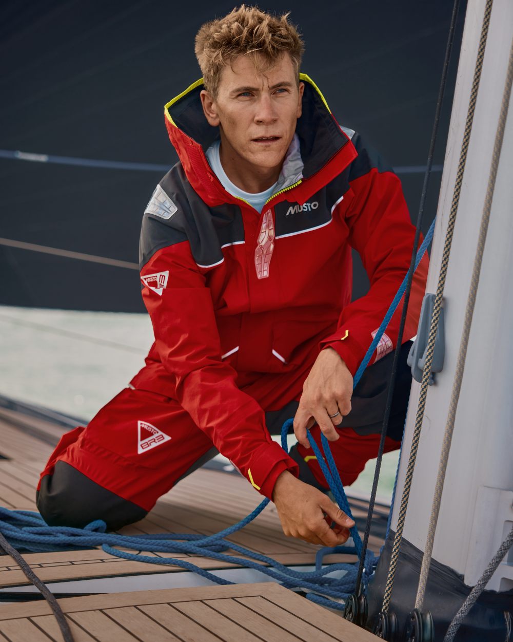 True Red coloured Musto Mens BR3 Pertex Offshore Jacket on ship background 