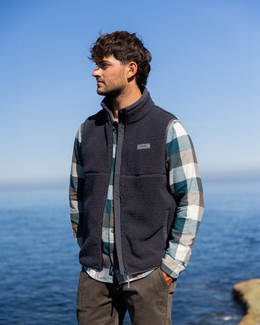 Carbon Coloured Musto Mens Cover Deep Pile Fleece Vest on sea background 