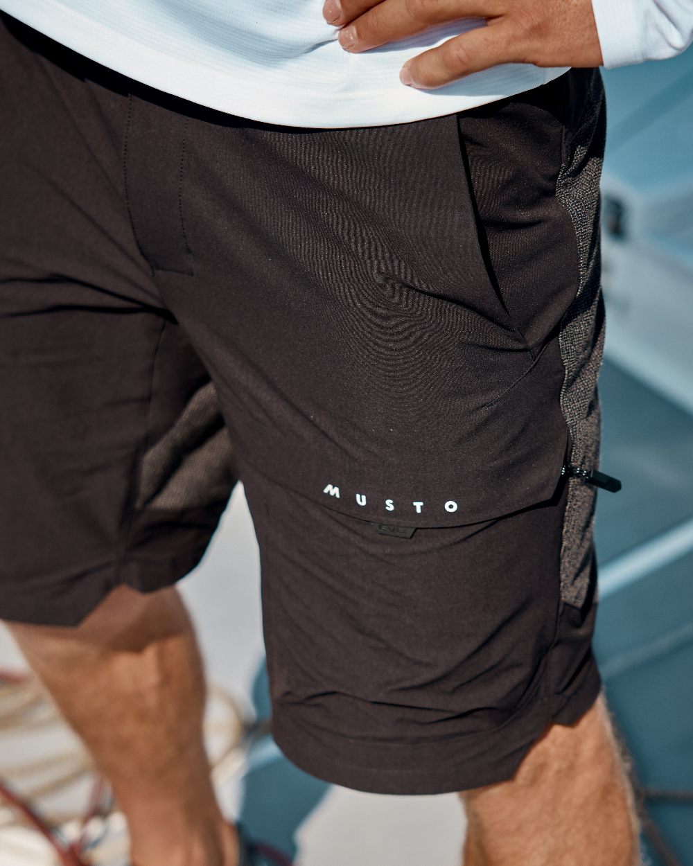 Black Coloured Musto Mens Evo Performance Stretch Shorts on outdoor background 