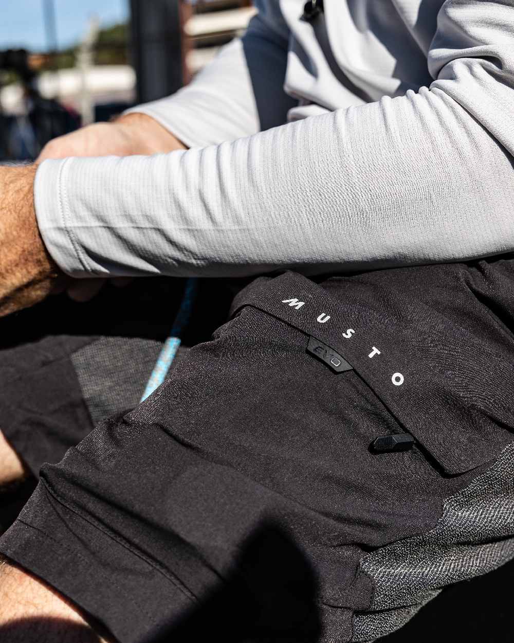 Black Coloured Musto Mens Evo Performance Stretch Shorts on outdoor background 