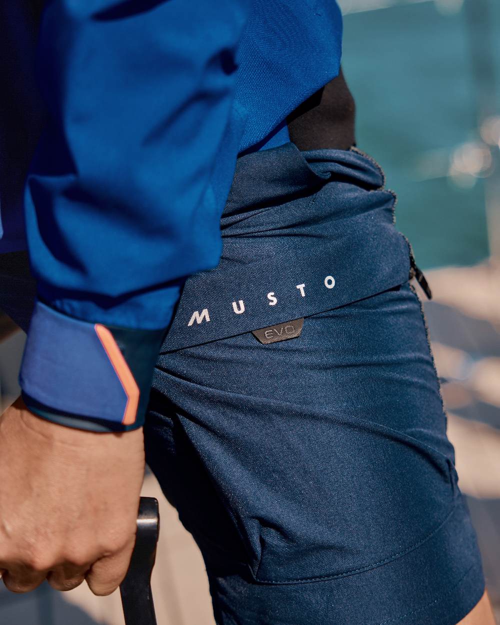 True Navy Coloured Musto Mens Evo Performance Stretch Shorts on outdoor background 