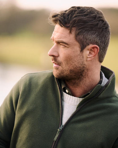 Deep Green Coloured Musto Mens Fenland 200 Polartec Fleee Jacket on Outdoor Background 