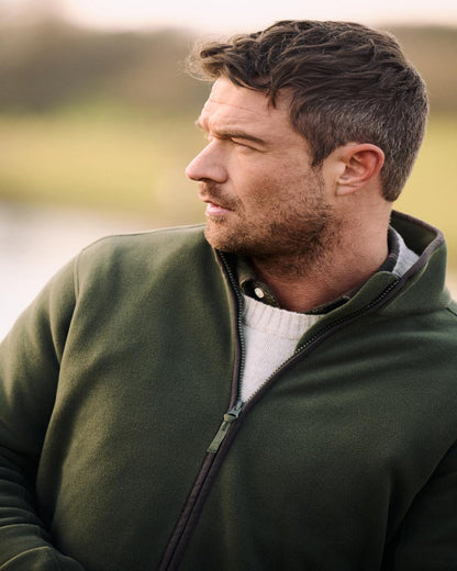 Deep Green Coloured Musto Mens Fenland 200 Polartec Feece Jacket on Outdoor Background 