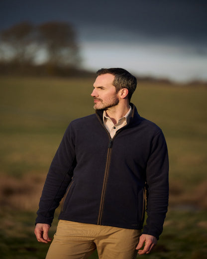 Navy Coloured Musto Mens Fenland 200 Polartec Fleece Jacket on Garden Background 