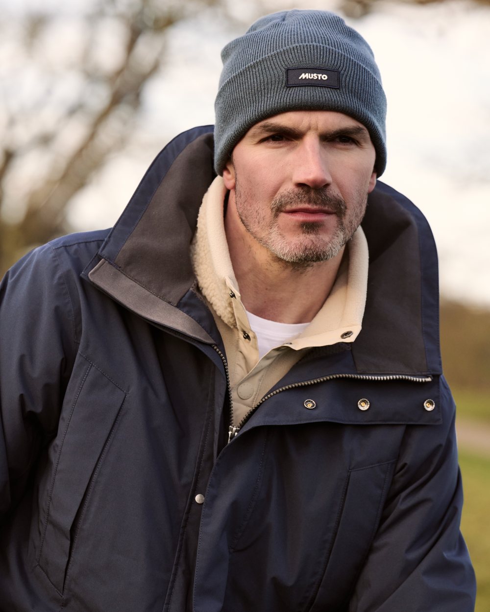 Navy Coloured Musto Mens Fenland Jacket 3.0 on country Background 