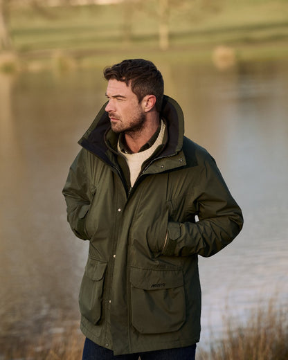 Deep Green Coloured Musto Mens  Fenland Jacket 3.0 on Sea Background 