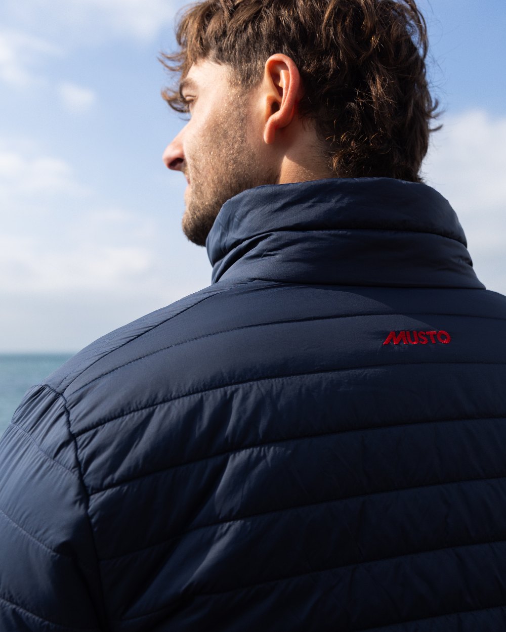 Navy Coloured Musto Mens Original Lite Puffer Jacket on outdoor background 