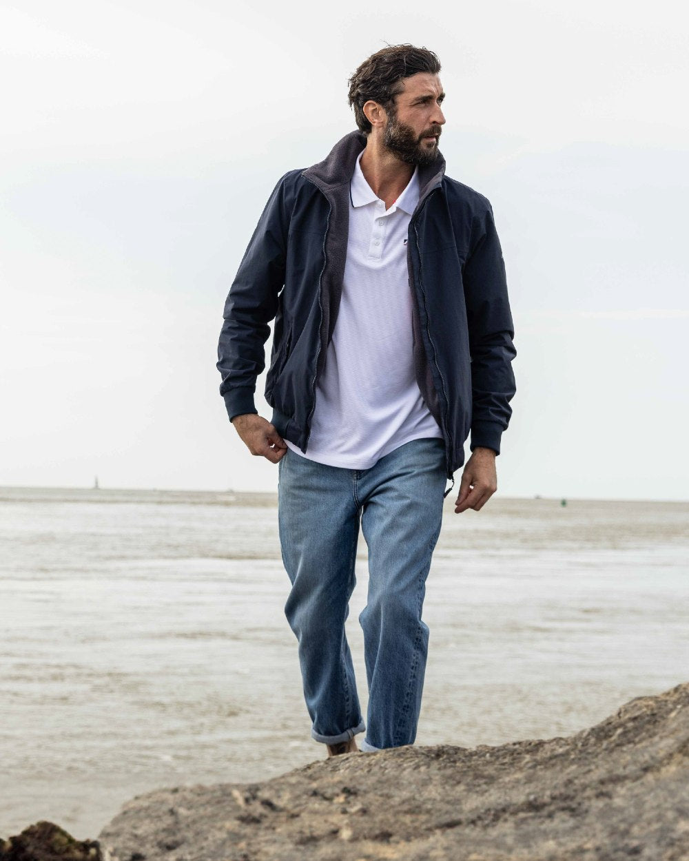 Navy Carbon coloured Musto Snug Blouson Jacket 2.0 on beach background 