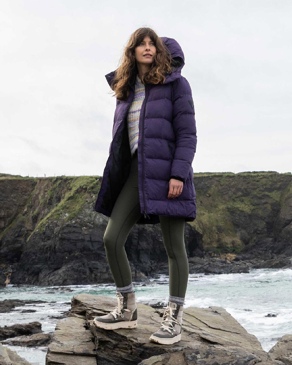 Mulberry Coloured Musto Womens Active Puffer Coat on sea background 