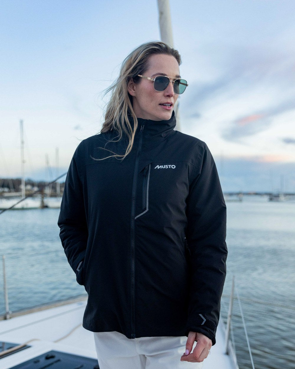 Black Coloured Musto Womens Br1 Primaloft Midlayer Jacket on ocean background 