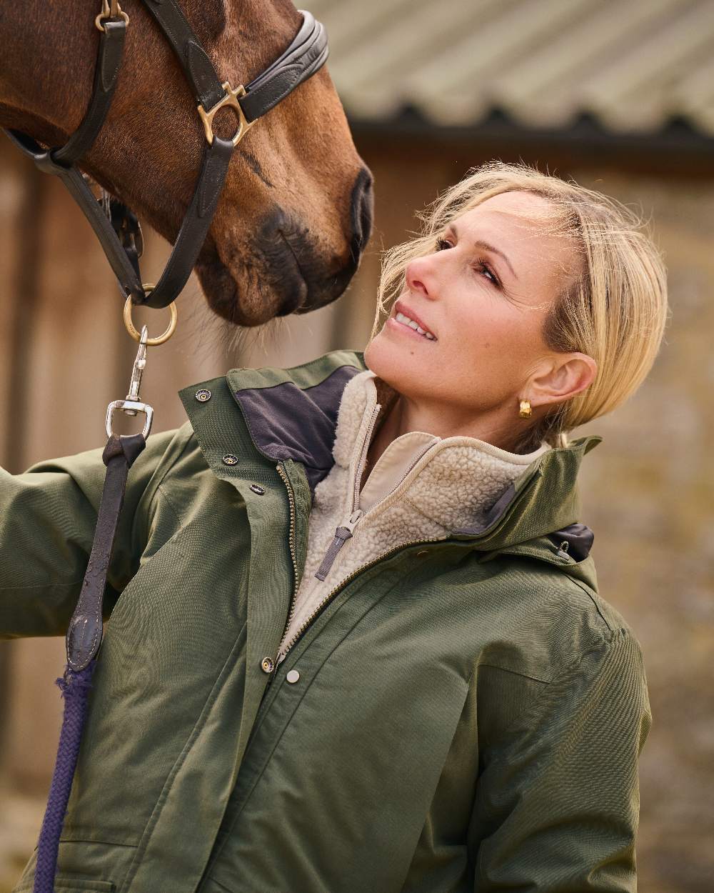 Deep Green Coloured Musto Womens Burnham Waterproof Jacket on Outdoor Background 