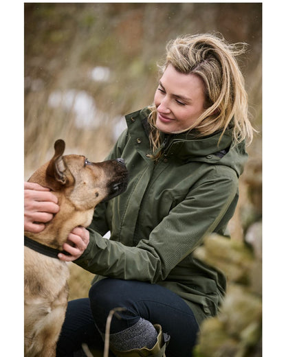 Deep Green Coloured Musto Womens Burnham Waterproof Jacket on Natural Outdoor Background 