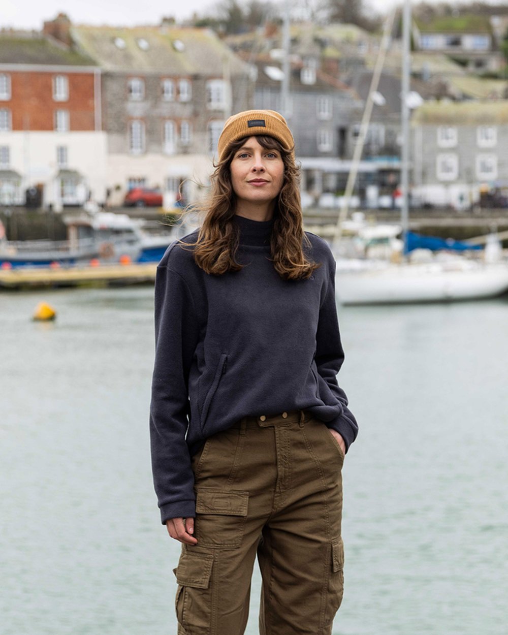 Carbon Coloured Musto Womens Classic Fleece Pullover On A Blurry lake Background 