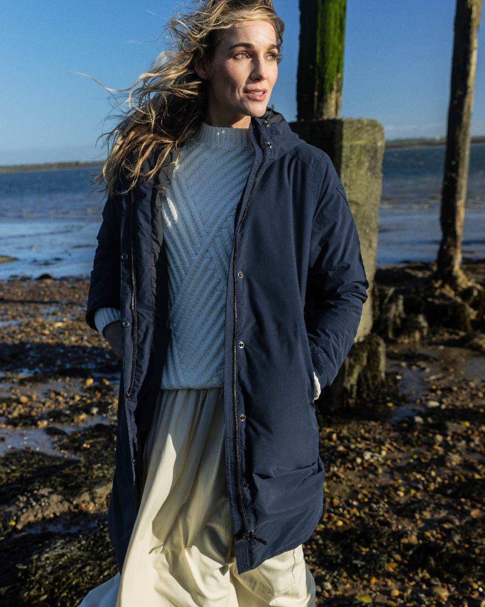 Navy coloured Musto Womens Corsica Primaloft Longline Parka on sea background 