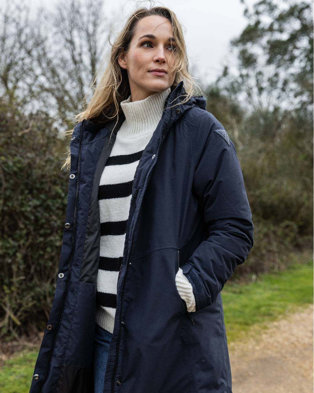 Navy coloured Musto Womens Corsica Primaloft Longline Parka on tree background 