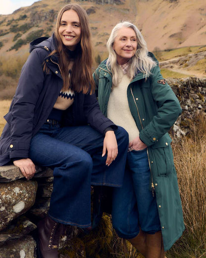 Darkest Spruce Coloured Musto Womens Odyssey Waterproof Coat on outdoor background 