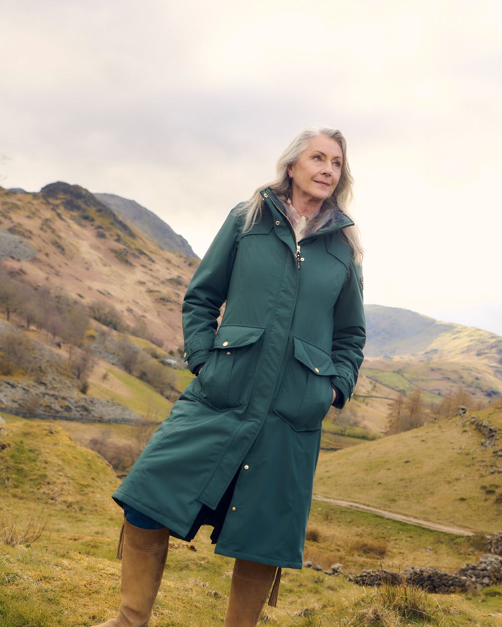 Darkest Spruce Coloured Musto Womens Odyssey Waterproof Coat on outdoor background 