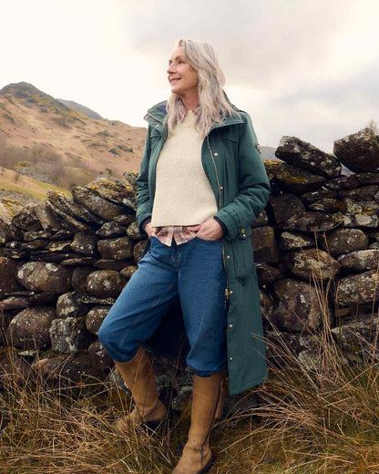 Darkest Spruce Coloured Musto Womens Odyssey Waterproof Coat on outdoor background 