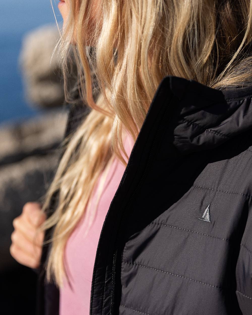Carbon Coloured Musto Womens Original Lite Puffer Coat on sea background 