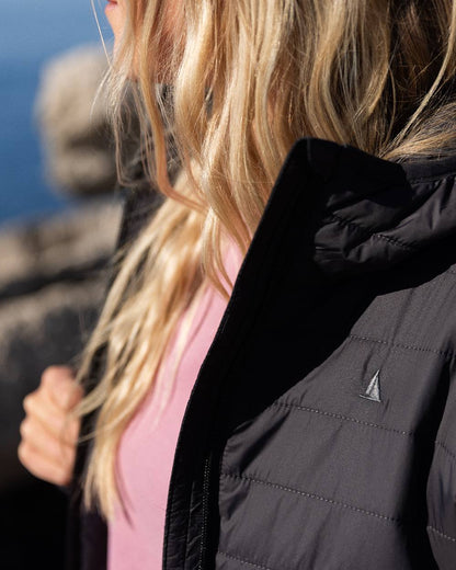 Carbon Coloured Musto Womens Original Lite Puffer Coat on sea background 