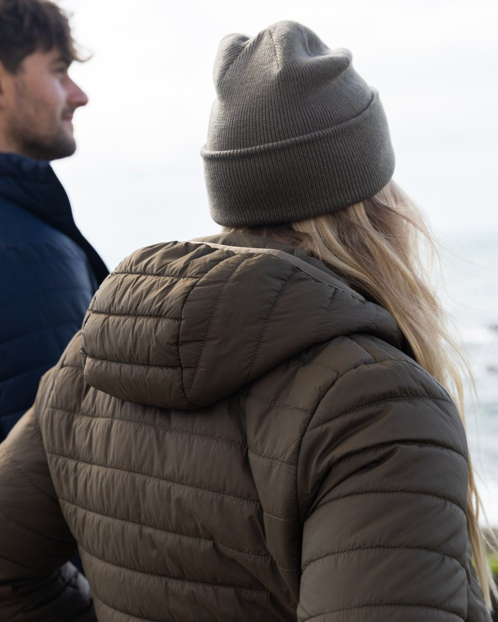 Crocodile Coloured Musto Womens Original Lite Puffer Coat on sea background 