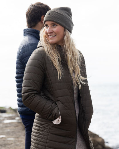 Crocodile Coloured Musto Womens Original Lite Puffer Coat on sea background 