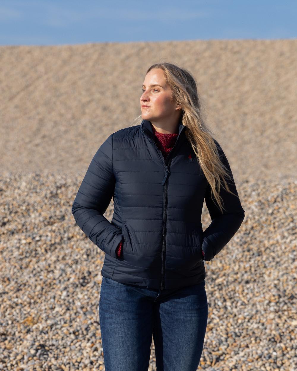 Navy Coloured Musto Womens Original Lite Puffer Jacket on beach background 