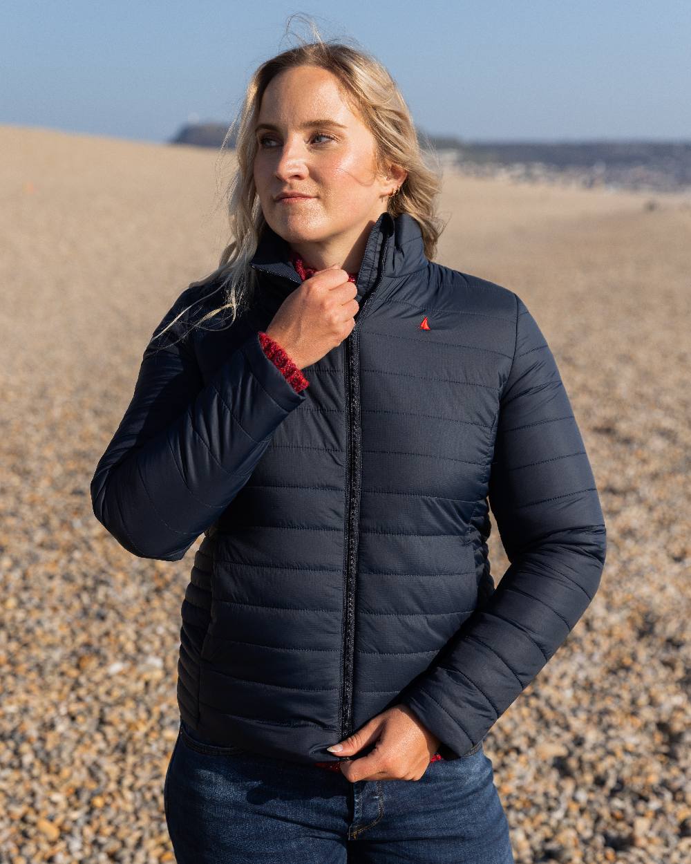 Navy Coloured Musto Womens Original Lite Puffer Jacket on beach background 