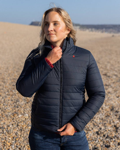 Navy Coloured Musto Womens Original Lite Puffer Jacket on beach background 