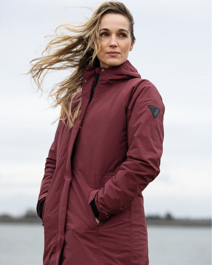 Windsor Wine coloured Musto Womens Primaloft 3 in 1 Parka on Sea background 