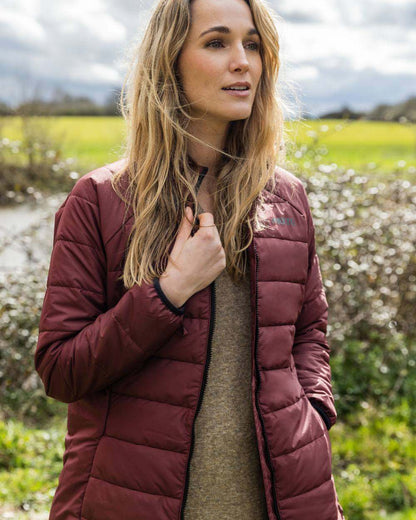 Windsor Wine coloured Musto Womens Primaloft 3 in 1 Parka on garden background 